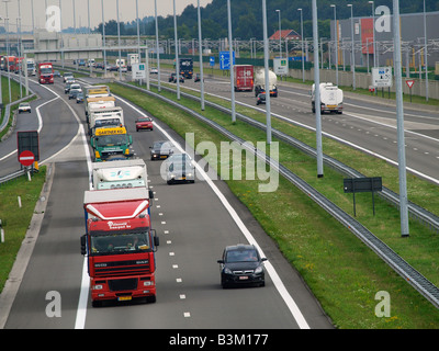 Long line of trucks on the E19 highway near the Dutch Belgian border looking south near Hazeldonk Meer Flanders Belgium Stock Photo