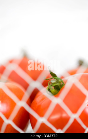 Tomatoes In White Wire Mesh Basket At Market Stock Photo