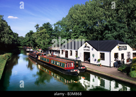 Narrow boats moored at Farncombe Boathouse, River Wey Navigation, near Godalming Surrey Stock Photo