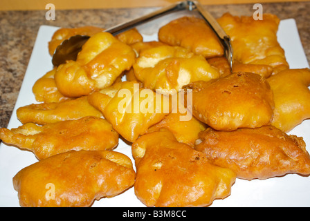 Deep fried halibut fillet in golden crisp batter on a big serving plate Stock Photo