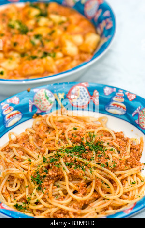 Spaghetti with Fish bolognese gnocchi with tomato on background Stock Photo