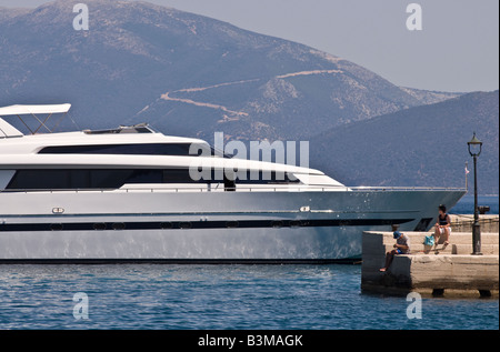 A luxury yacht receives an admiring glance in the harbour at Sami Kefalonia Greece Stock Photo