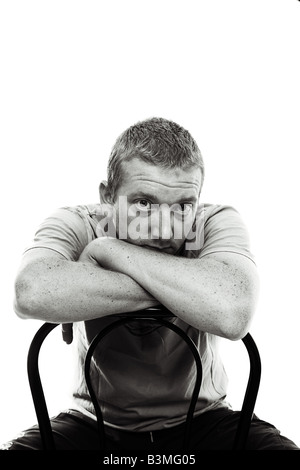 Male sitting on Chair against White Background looking at the camera Stock Photo