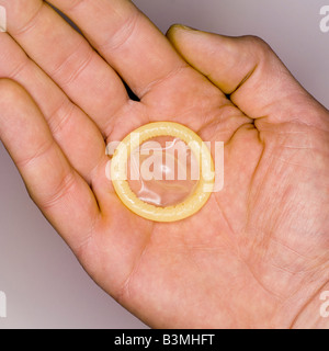 Condom on man's hand, elevated view, close-up Stock Photo