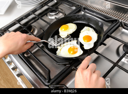 MAN FRYING EGGS Stock Photo