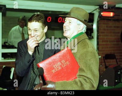 Michael Aspel TV Presenter catches racehorse jockey Richard Dunwoody in the weighing room after the main race at Ascot mirrorpix Stock Photo