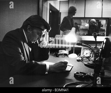 Sir Robin Day TV Presenter and Broadcaster sits in a radio studio studying his script and notes before presenting a show Stock Photo