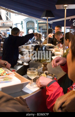 Street front restaurant 'Mer du Nord' serving freshly cooked seafood directly to standing customers, Brussels Belgium Stock Photo