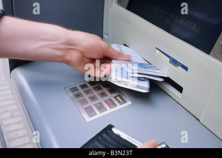 Spain, withdrawing at a cashpoint, close up Stock Photo