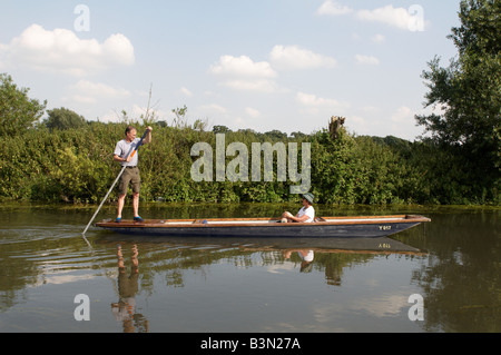 Middle aged couple Punting on River Cam between Cambridge and Grantchester Stock Photo