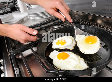 MAN FRYING EGGS Stock Photo