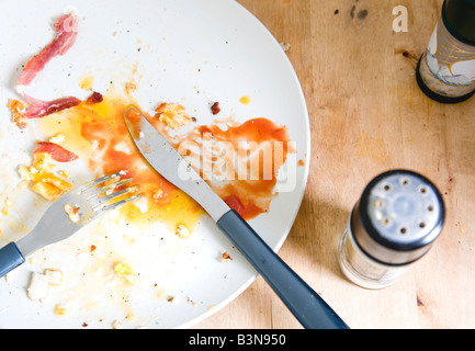 dirty plate with knife and fork Stock Photo
