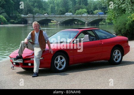 Les Dennis Comedian TV Presenter December 97 Sitting on the bonnet of the new Ford Probe Stock Photo