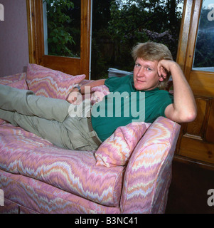 Mike Smith DJ disc jockey TV presenter lying lounging on couch settee sofa mirrorpix Stock Photo