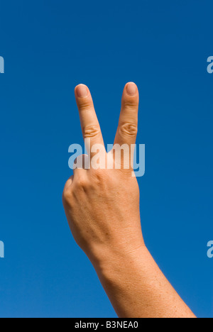 Model Released Detail of female forming an abusive V sign Stock Photo