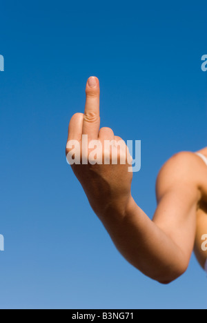 Model Released Detail of female hand showing an abusive middle finger sign or so called Flicking the Bird Stock Photo