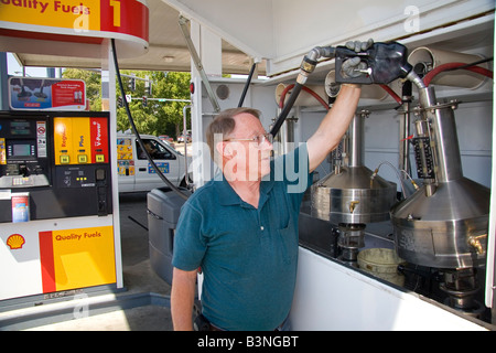 Bureau of Weights and Measures inspector testing gasoline octane rating ...
