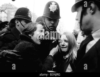 Upset Beatles fans crying because Paul McCartney got married are led away by police March 1969 Stock Photo