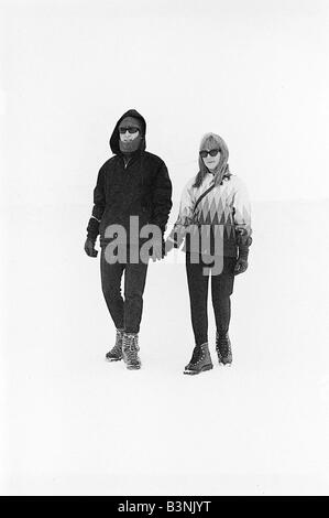 Beatles singer John Lennon with his wife Cynthia on a skiing holiday in St Moritz Switzerland January 1965 Stock Photo