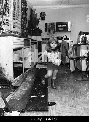 Interior view of a London terraced house showing a child in the kitchen March 1983 Stock Photo