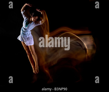 dancer jumping through the air showing motion as trails of light impact spiritual,professional,accomplished,posed,working,photos Stock Photo