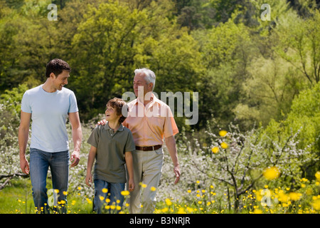 Germany, Baden Württemberg, Tübingen, Family walking in wooded meadow Stock Photo