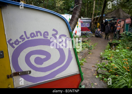 In the Scottish woodland  brighly-coloured customised caravan homes at the makeshift Faslane Peace Camp Stock Photo