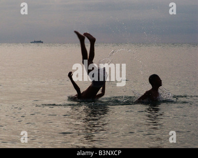 two boys playing in the sea Stock Photo - Alamy