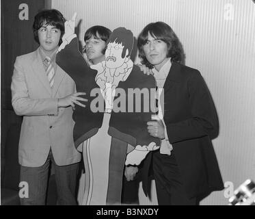 The Beatles 1968 left to right Paul McCartney Ringo Starr and George Harrison with a cardboard cut out of John Lennon from the film Yellow Submarine Stock Photo