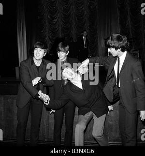 The Beatles November 1963 John Lennon Ringo Starr Paul McCartney and George Harrison fooling around in Plymouth Stock Photo