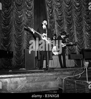 The Beatles November 1963 Paul McCartney singing and playing bass guitar on stage during their gig in Plymouth Stock Photo