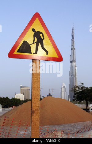 men at work sign with Burj Dubai tower in background, Dubai Stock Photo