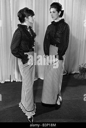 Fashions taken during London Fashion Week 1964 Black frilly blouses with striped ankle length skirts Stock Photo