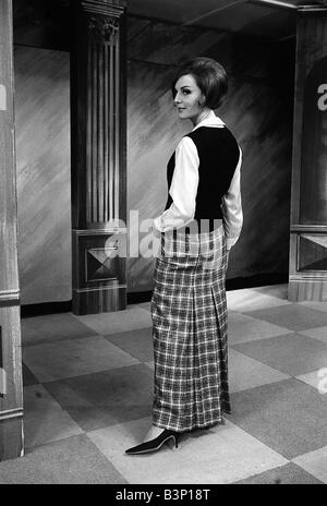 Fashions taken during London Fashion Week 1964 Ankle length Plaid skirt with white Blouse and black sleeveless jumper Stock Photo