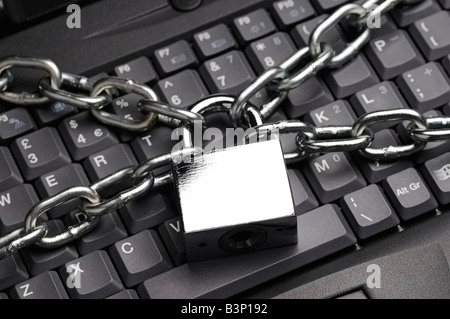 Padlock and Chain on Laptop Computer Keyboard Stock Photo
