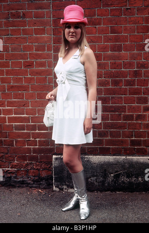 1968 Clothing Ascot Fashion Hats and Dresses Rosamond Kent pink hat white dress and silver knee high boots Stock Photo