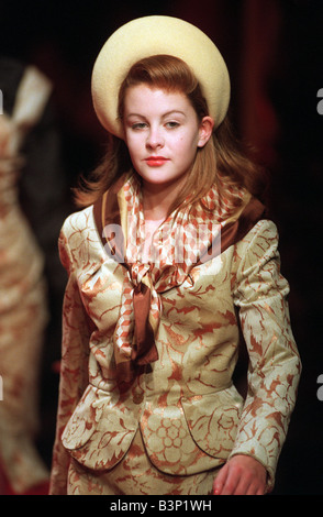 Lara Copcutt February 1997 Model aged 13 years old from Surrey England a pupil at the Sylvia Young Theatre School in London Pictured during showing of Vivienne Westwood s Red Label collection at the Dorchester Hotel marking the beginning of London Fashion Week this was the designer s first show in the capital for eight years London Fashion Week 1997 Child model on the catwalk dressed in adult clothing jacket and skirt with neck scarf with a hat Stock Photo