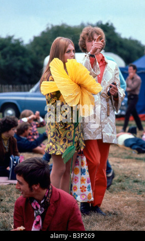 Sixties fashion 1960s Festival of the Flower Children Hippy hippies with giant large yellow flower Unusual clothing Windsor Jazz Festival 12 08 1967 CR3740 2 August 1967 Mirrorpix Stock Photo