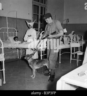 Suez Crisis 1956 Royal Marine Andrew Hall accompanies Sister Mary Joseph on her rounds at a hospital in Port Said Sister Mary from the Sister of Charity Convant in London has tended the sick at the hosptal for three years The armed guard was assigned to her after she received death threats for tipping off the British army that fifty rifles and a large quantity of ammunition were hidden in a clothes store Stock Photo