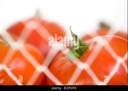 Tomatoes In White Wire Mesh Basket At Market Stock Photo