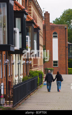 Couple walking hand in hand past townhouses on Bathurst Basin Bristol England UK Stock Photo