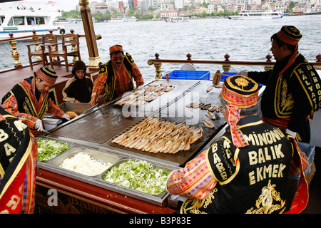 May 2008 - Freshly fried fishes being prepeared on a boat in Eminonu Istanbul Turkey Stock Photo