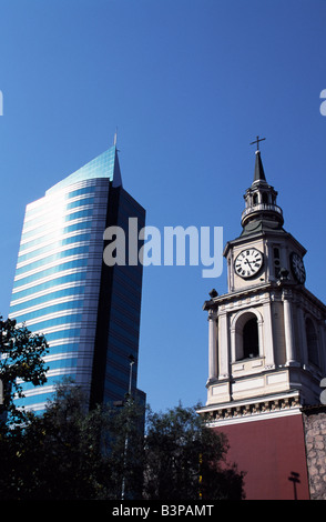 Chile, Santiago. Rising either side of Avenida del Libertador Bernardo O'Higgins, Santiago's main east-west throughfare, colloquially known as La Alameda, are the two faces of Santiago. On the left a modern high-rise office building and on the right the tower of Iglesia San Francisco, Santiago's oldest building (built in 1586-1628AD) Stock Photo