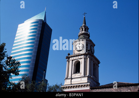 Chile, Santiago. Rising either side of Avenida del Libertador Bernardo O'Higgins, Santiago's main east-west throughfare, colloquially known as La Alameda, are the two faces of Santiago. On the left a modern high-rise office building and on the right the tower of Iglesia San Francisco, Santiago's oldest building (built in 1586-1628AD) Stock Photo