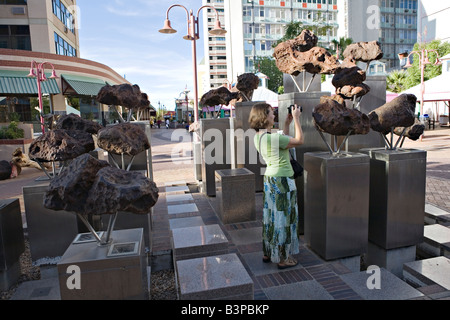 Traveller photographing large Gibeon irons on display in the Namibian capitol of Windhoek Stock Photo