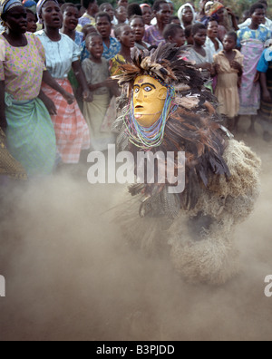 Malawi, Mua, Central Malawi. The Chewa people, Malawi's largest ethnic group, live on the west side of Lake Malawi. Despite years of missionary influence, they still cling to old beliefs and rituals. For them, death simply means a journey of rebirth into the spirit world. The terrestrial representatives of this other world are grotesquely masked dancers known as Gule Wamkulu. When a person dies, masked dancers appear at the funeral to welcome the deceased to the spirit world. Stock Photo