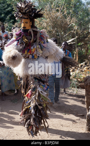 Malawi, Mua, Central Malawi. The Chewa people, Malawi's largest ethnic group, live on the west side of Lake Malawi. Despite years of missionary influence, they still cling to old beliefs and rituals. For them, death simply means a journey of rebirth into the spirit world. The terrestrial representatives of this other world are grotesquely masked dancers known as Gule Wamkulu. When a person dies, masked dancers appear at the funeral to welcome the deceased to the spirit world. Stock Photo