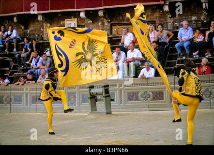 Historic Palio horse race, participants waving banners representing the Contrada di Aquila, Eagle District, Aquila, Piazza Il C Stock Photo