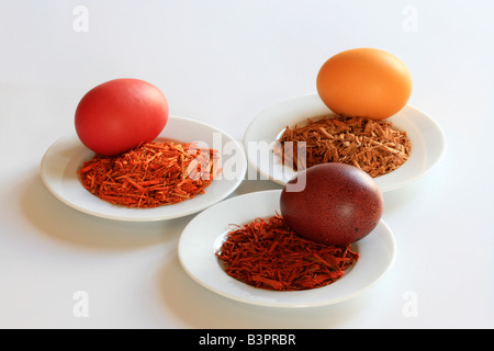 Yellow, red and brown wood used as natural dyers to colour easter eggs Stock Photo