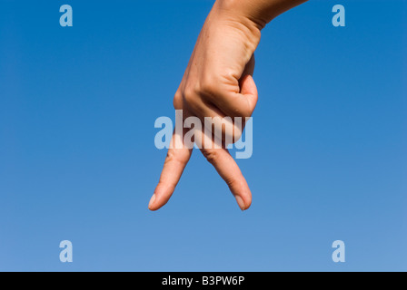 Model Released Detail of female hand forming a walking sign Stock Photo